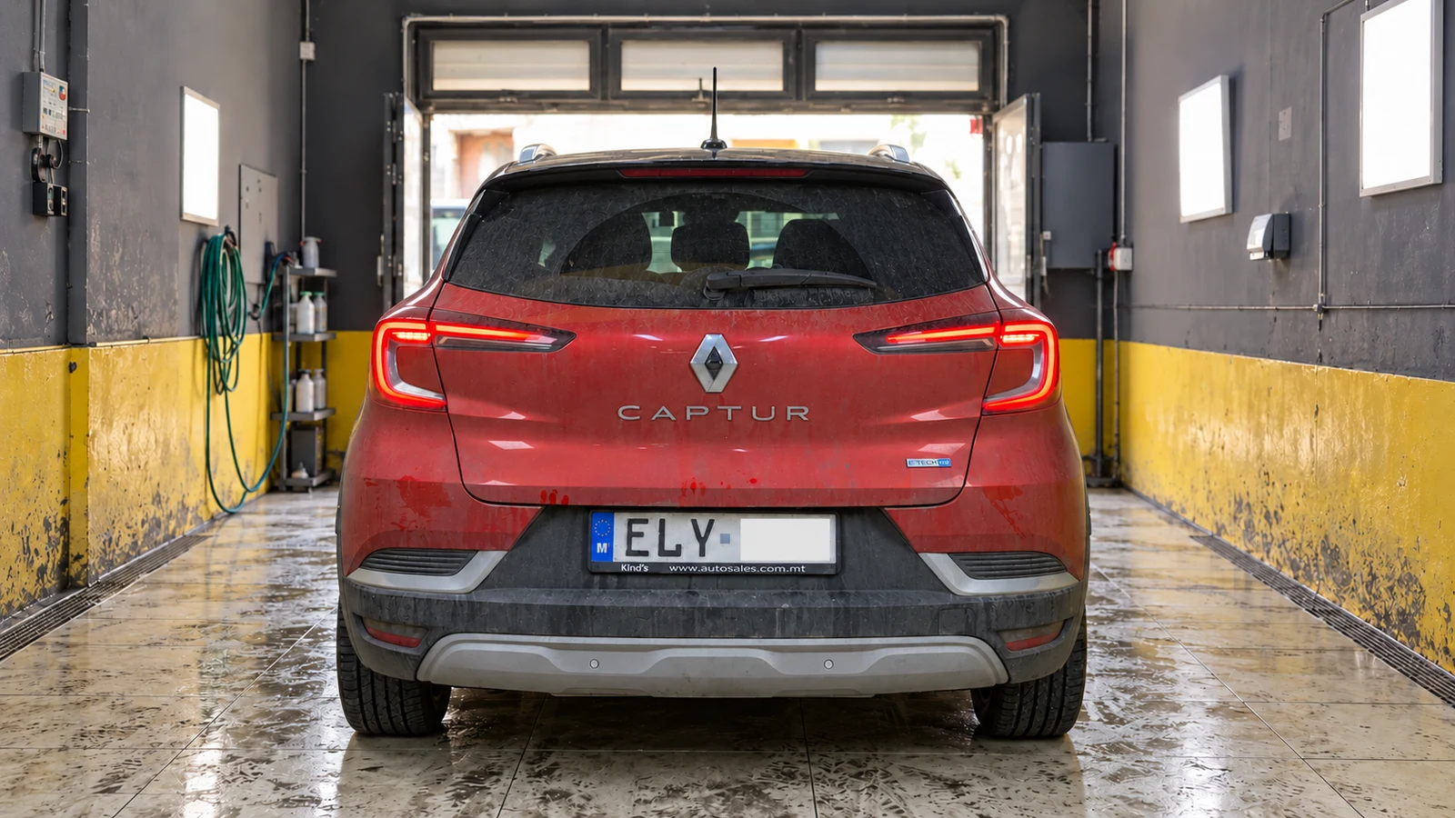 Red Renault Captur before detailing, with dusty glass and dirt on the paint and bumper