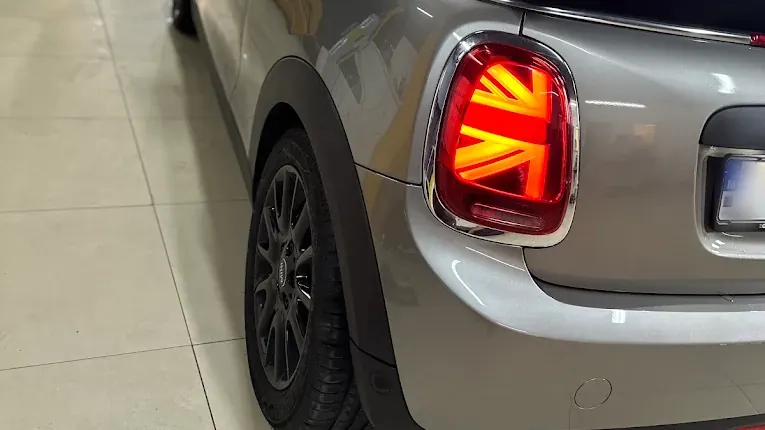 Close detail of a silver Mini convertible's Union Jack tail light and clean alloy wheel